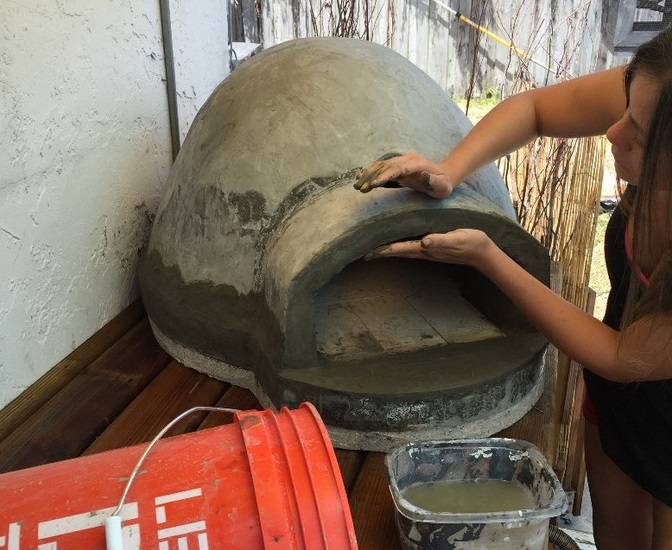 Wood-fired pizza oven built using exercise ball