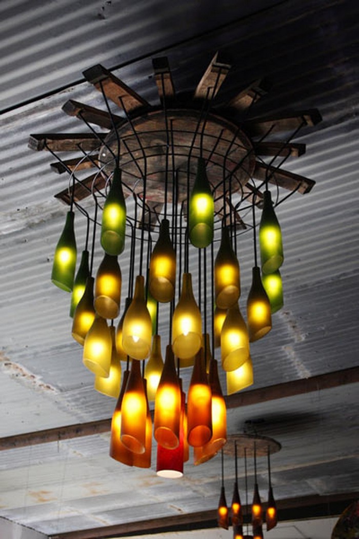Chandelier made of wine bottles with green yellow and orange lighting