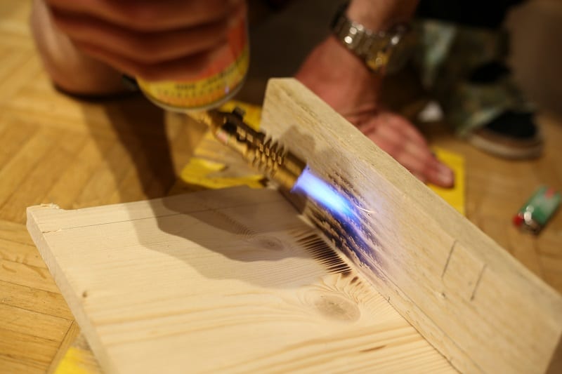 Using the blow torch, start “painting” the foundation with flames. 