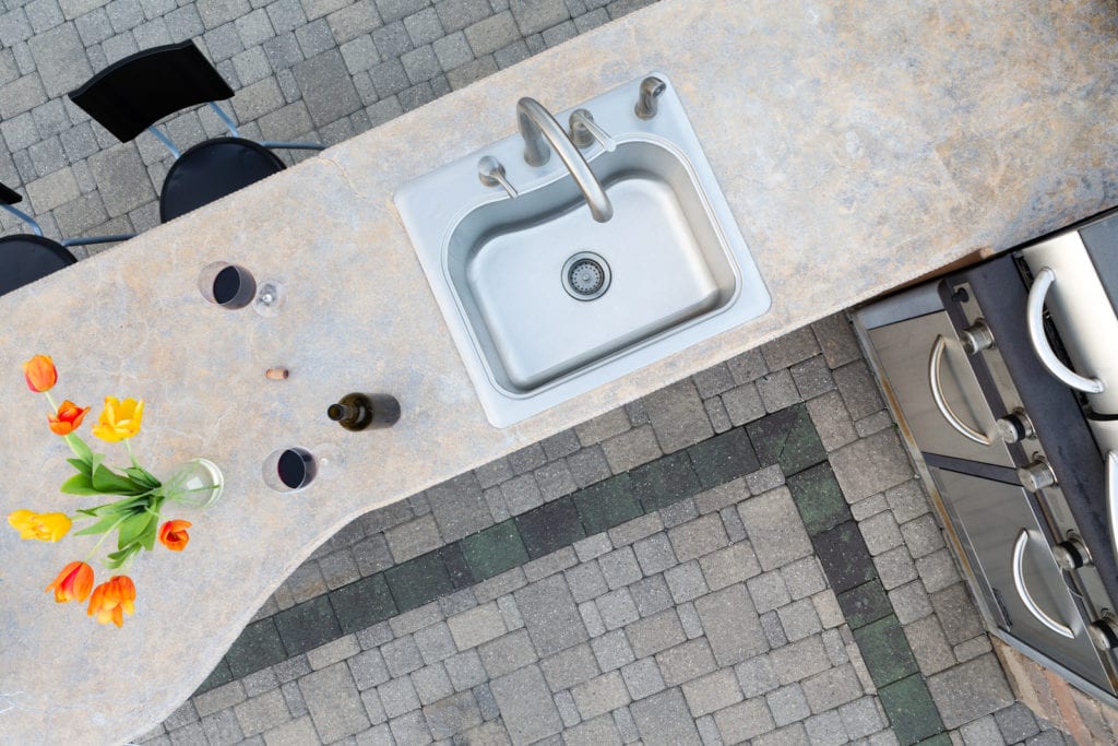 Experts recommend a granite, slate, or even stainless-steel counter top to match your grill. 