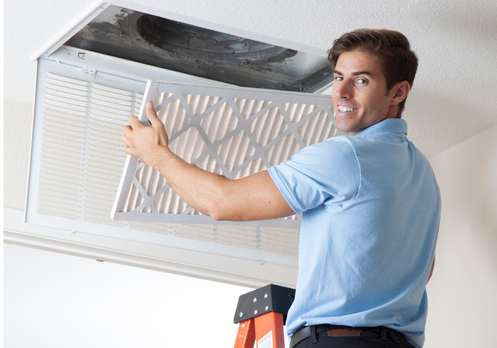 A man keeping clean air ducts by replacing the filter.